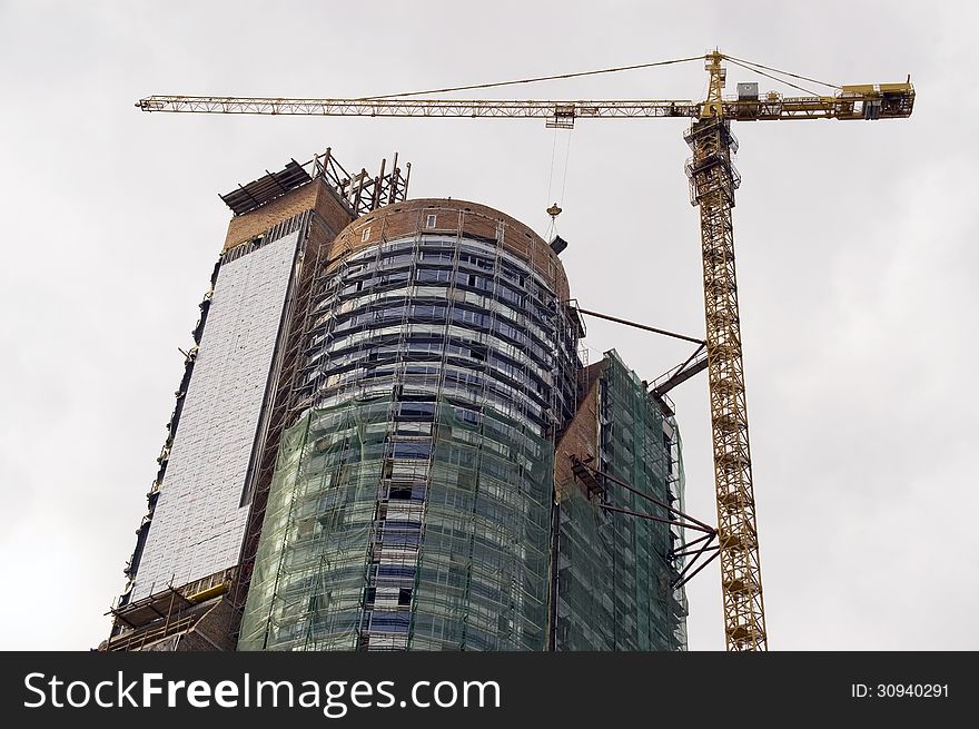 Crane working heavy construction. Modern Architecture.