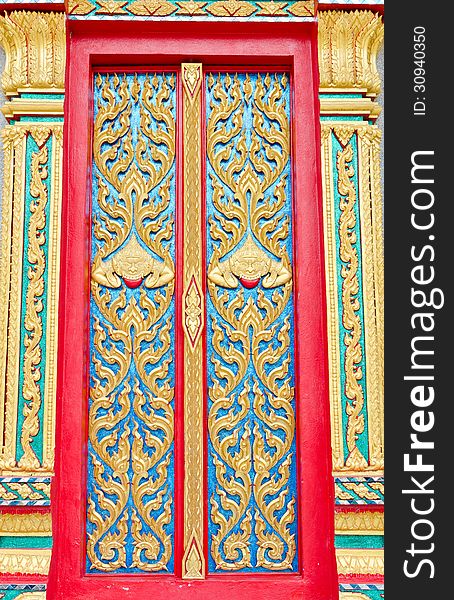 Golden and red Thai temple door sculpture