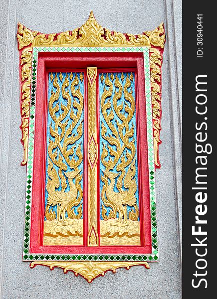 Golden and red Thai temple door sculpture