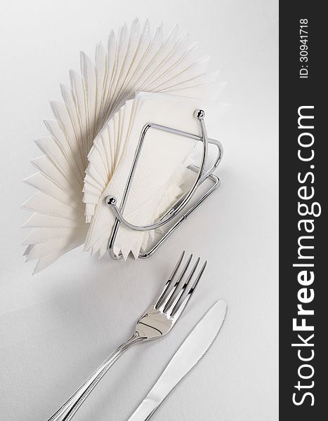 Empty served restaurant table with napkin, fork and knife