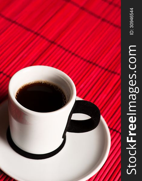 Fresh brewed coffee over red background. close up