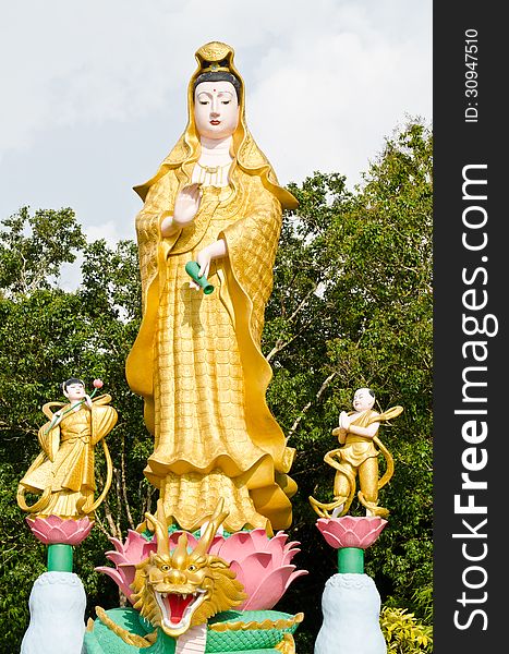 Golden Statue Of Guan Yin With Children In Temple At Phan Nga, T