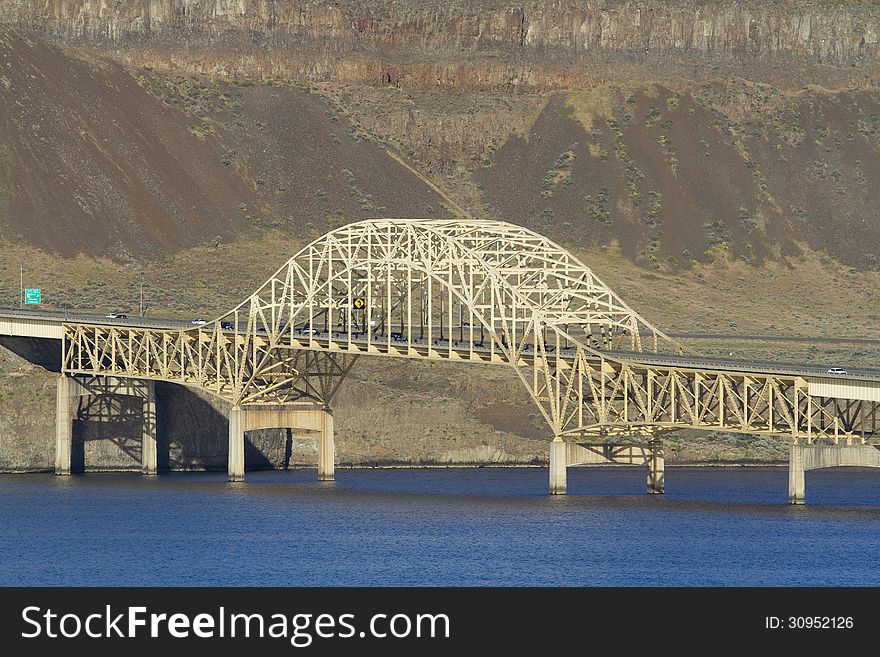 I-90 Vantage Bridge over the Columbia River Gorge in central Washington State Wide Angle with blue sky blue water rocky dry desert mountain hill Vantage