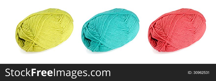 Yellow, green and red skeins of wool isolated on white background