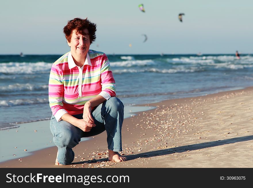 Happy senior woman on summer vacation at sea