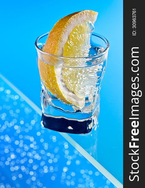 Gin with lemon on a glass table