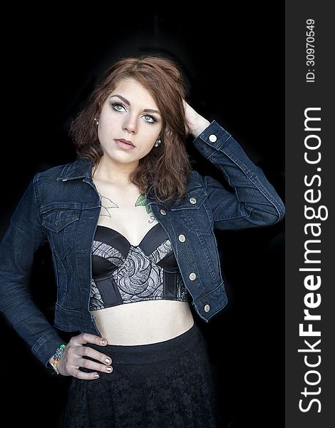 Portrait of a beautiful young woman in a black bustier. Portrait of a beautiful young woman in a black bustier.