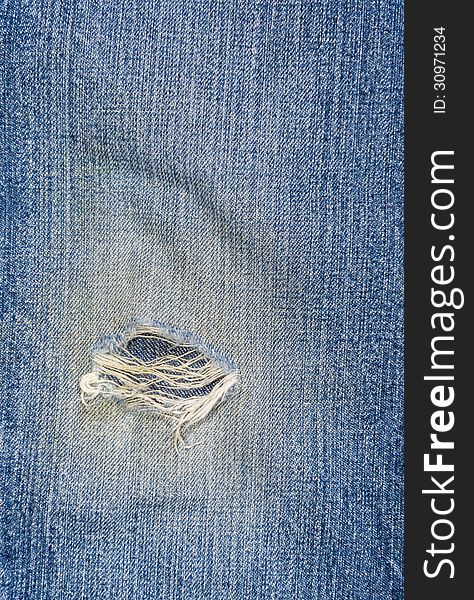 Close up of ripped blue jeans fabric. Close up of ripped blue jeans fabric