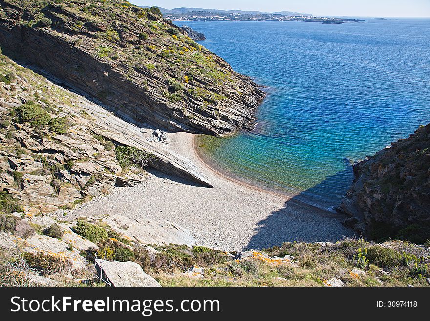 Sa Cebolla bay, a popular tourist destination along the path to the Cala Nans Lighthouse in Cadaques Spain. Sa Cebolla bay, a popular tourist destination along the path to the Cala Nans Lighthouse in Cadaques Spain