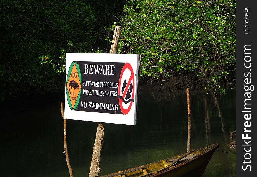 This NO SWIMMING danger tag was placed inside a sea bay to alert people the presence of crocodiles. This NO SWIMMING danger tag was placed inside a sea bay to alert people the presence of crocodiles.