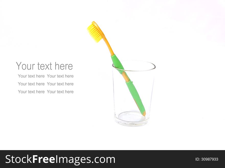 Toothbrush in the glass isolated on white background  with sample text for your design.