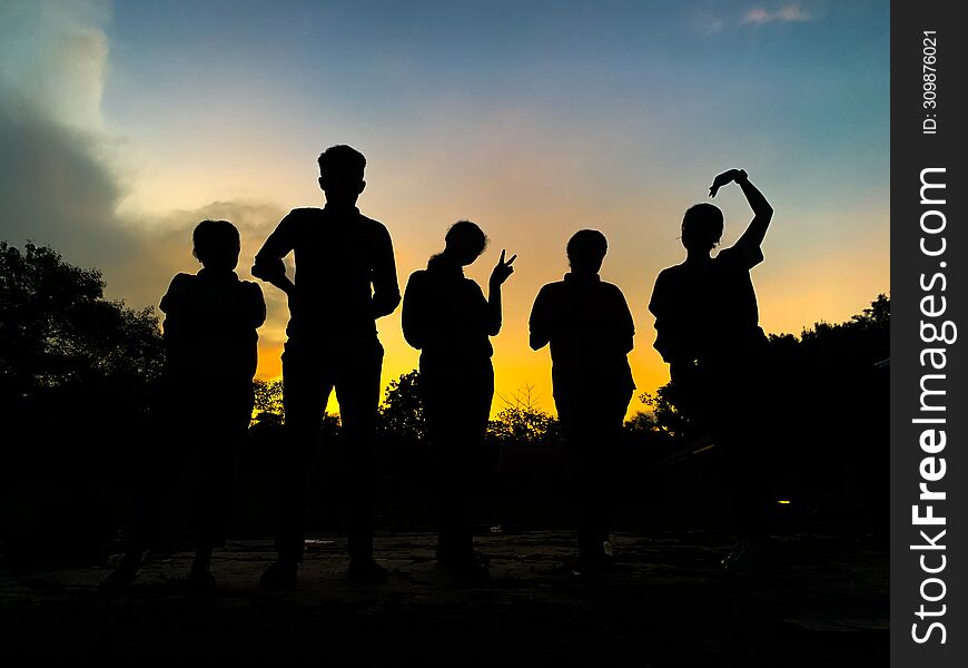 Silhouette of a group of people in the twilight sky
