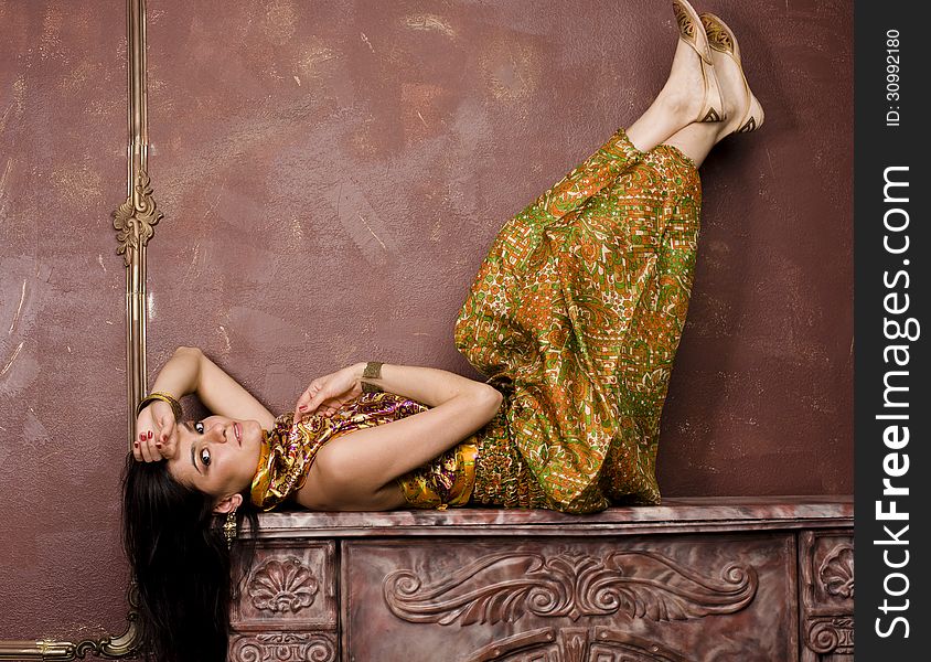 Portrait of beauty sensual young woman in oriental style in luxury room