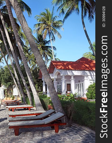 Beach chairs  and  luxury houses in tropical resor