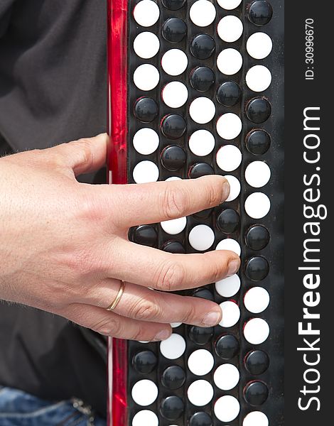 Man's hand on the accordion keyboard closeup. Man's hand on the accordion keyboard closeup