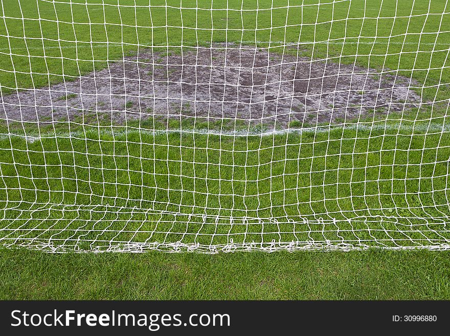Goalmouth on football field. view through the mesh gate. Goalmouth on football field. view through the mesh gate