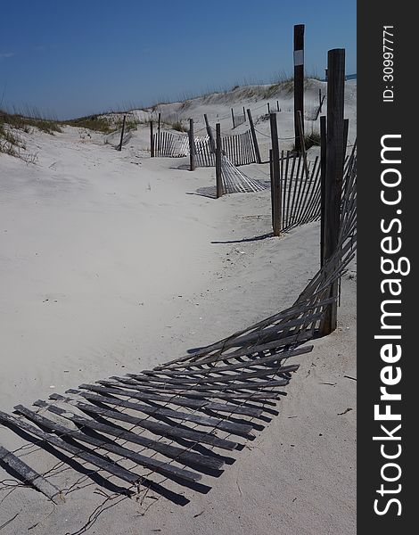 Fences on white sandy beach