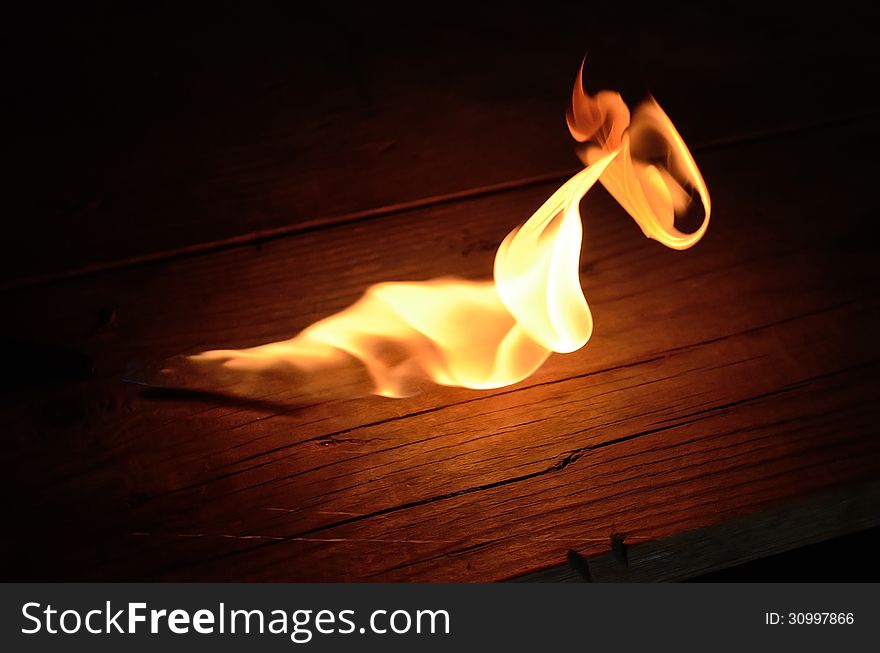 Flame of gas burner on the wooden floor. Flame of gas burner on the wooden floor.