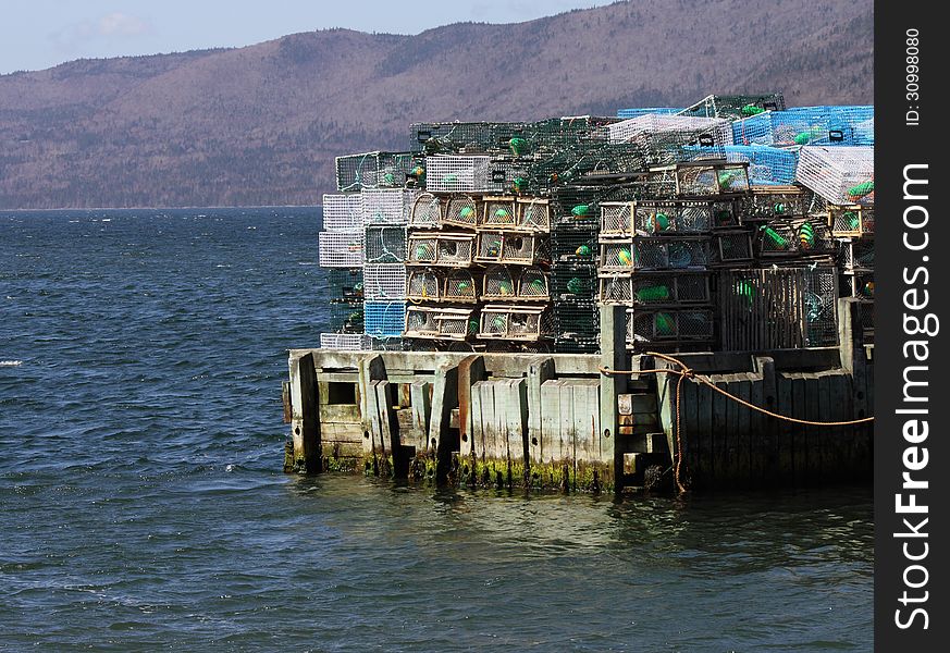 Lobster traps sit stacked on a wharf in Nova Scotia, Canada. Lobster traps sit stacked on a wharf in Nova Scotia, Canada.