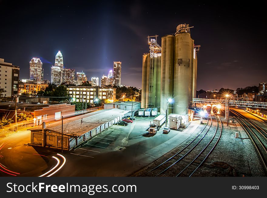 Charlotte City Skyline and architecture at night and milling factory. Charlotte City Skyline and architecture at night and milling factory