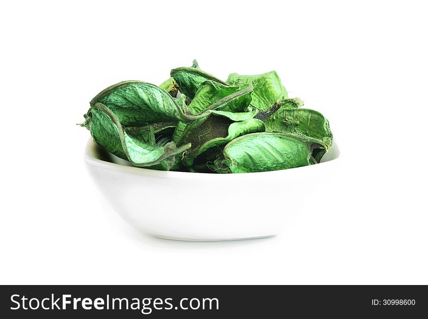 Aromatic green leaves in a bowl of sauces. Aromatic green leaves in a bowl of sauces.