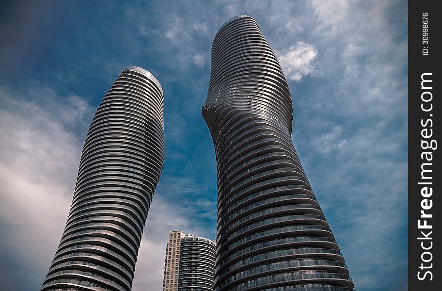 Modern style building towers against dark blue sky. Modern style building towers against dark blue sky