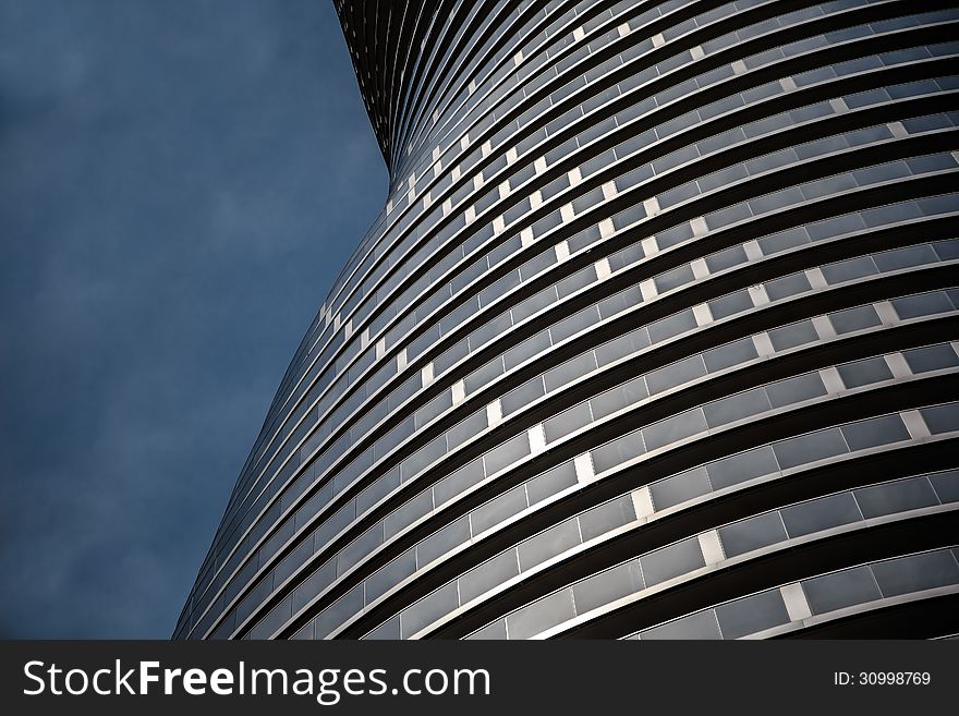 Modern styled condo building side wall on dark blue sky