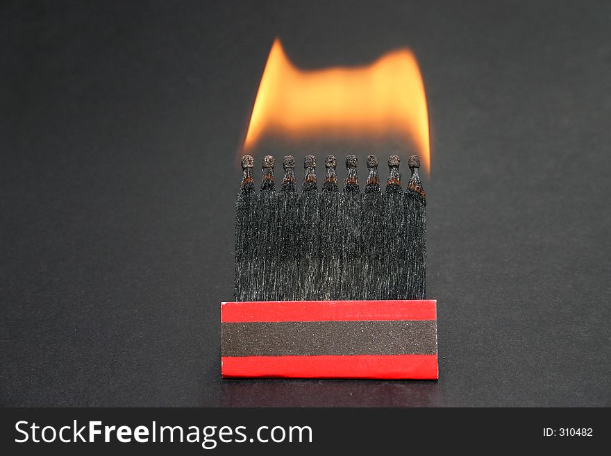 A box of burning matches on balck background