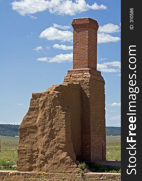 A brick chimney, pieces of the foundation, and the remains of an adobe wall are all that remain of one of the officers' quarters at old Fort Union National Monument in New Mexico. A brick chimney, pieces of the foundation, and the remains of an adobe wall are all that remain of one of the officers' quarters at old Fort Union National Monument in New Mexico.