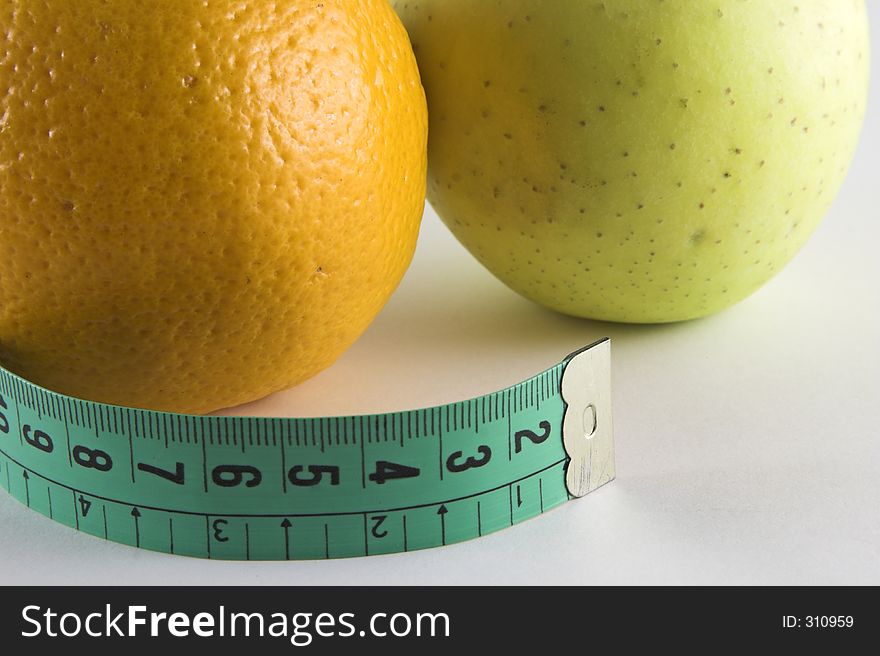 Apple, orange a tape isolated over white background. Apple, orange a tape isolated over white background