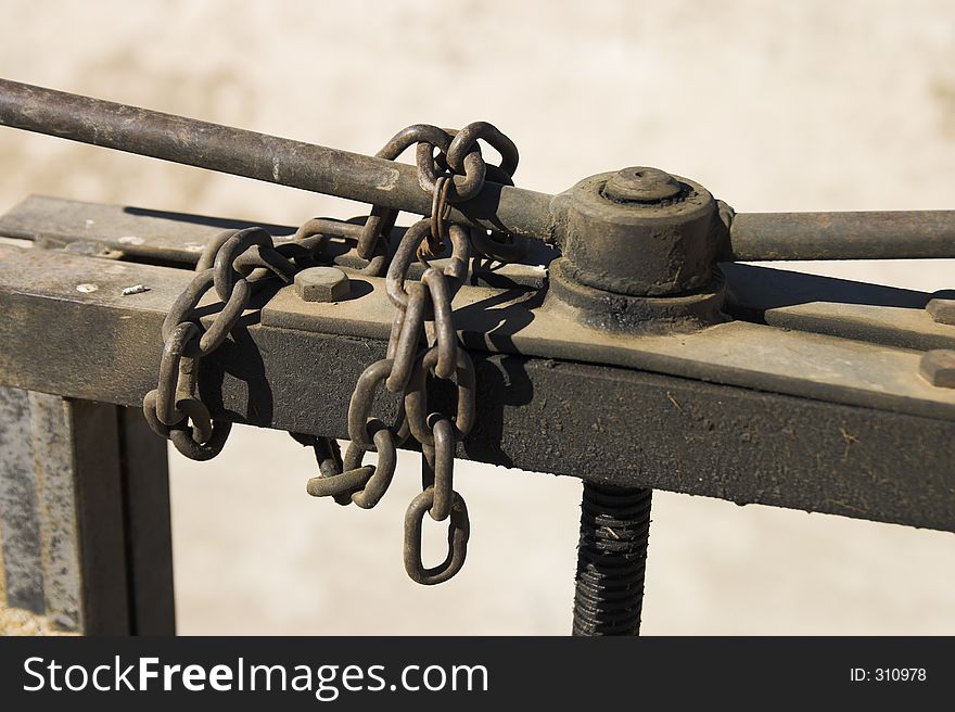 Metal Chain closing a rusty sluice. Metal Chain closing a rusty sluice