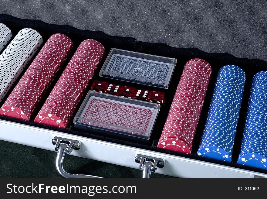 An alluminum case of poker chips with dice and cards. An alluminum case of poker chips with dice and cards