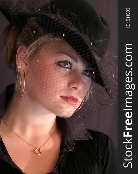 Beautiful young woman dressed in forties style dress and hat. Beautiful young woman dressed in forties style dress and hat.