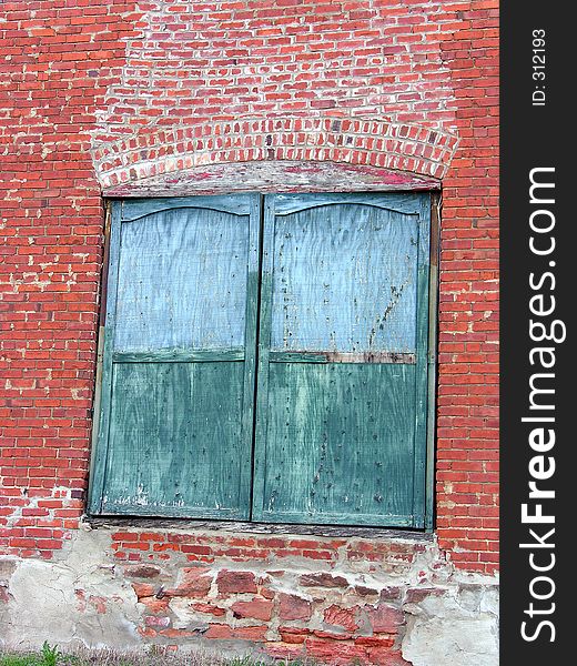 Two green freight doors hang in their antique brickwork from turn of the century railroad depot in Guthrie, Oklahoma. Two green freight doors hang in their antique brickwork from turn of the century railroad depot in Guthrie, Oklahoma.