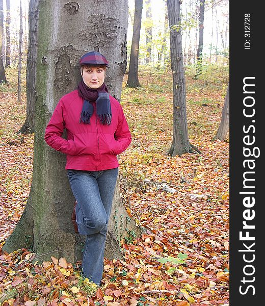 Model in vizored cap and muffler resting against a tree. Model in vizored cap and muffler resting against a tree