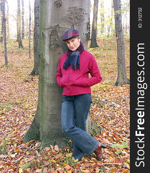 Model in vizored cap and muffler resting against a tree. Model in vizored cap and muffler resting against a tree