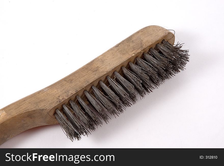 A wire brush photographed from the side