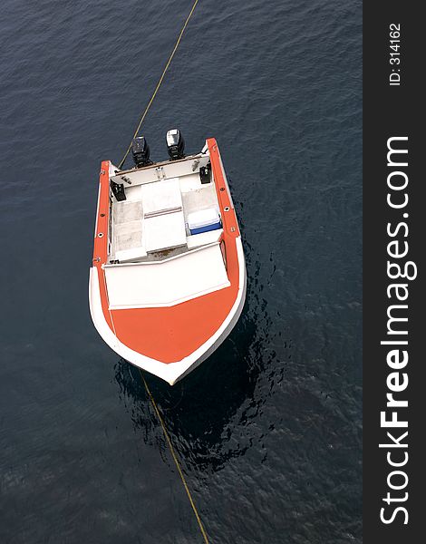 Close up of orange boat floating on ocean