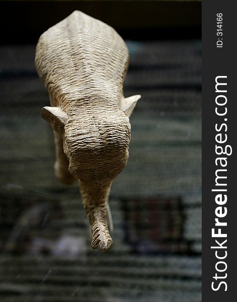Elephant carved out of wood standing on table. Elephant carved out of wood standing on table