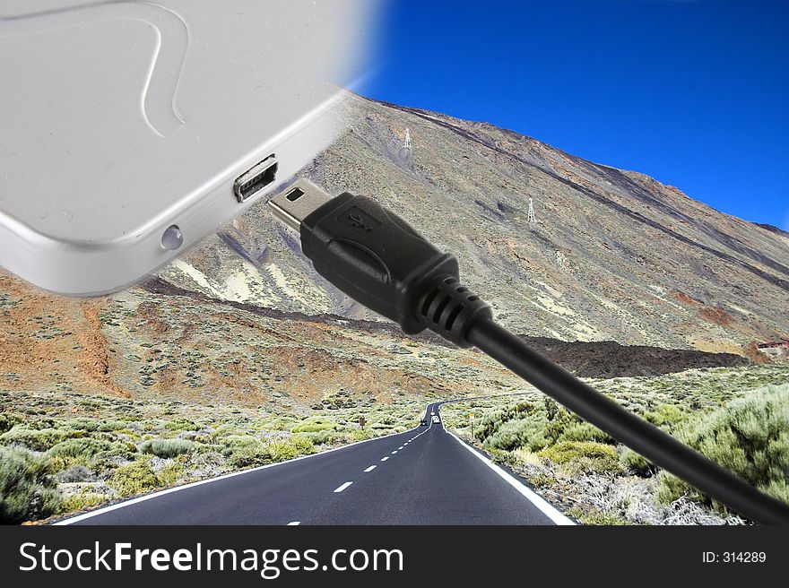 Mini usb cable cord and external hard drive over a landscape with a road. Mini usb cable cord and external hard drive over a landscape with a road