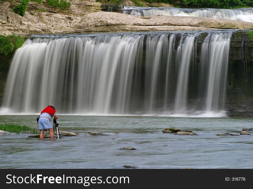 Man in water shooting waterfall. Man in water shooting waterfall