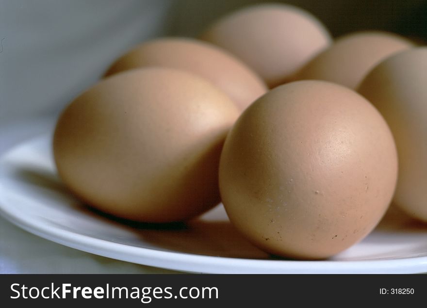 Softly lit close-up of whole eggs on a plate