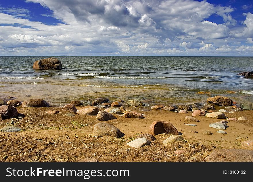 Landscape with blue sky, clouds, stones and sea. Landscape with blue sky, clouds, stones and sea