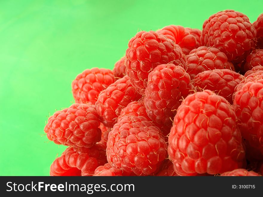 Red raspberry on  green background