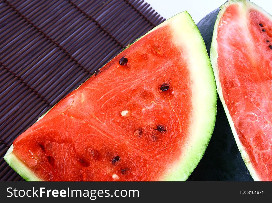 Background of brightly lit red watermelon slices.