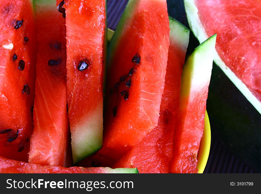 Background of brightly lit red watermelon slices.