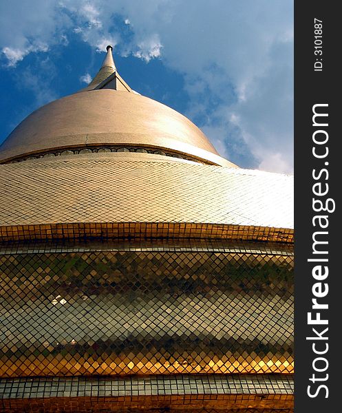 Top of a Thai Buddhist temple in the Grand Palace, Bangkok, Thailand, covered in gold leaf. Top of a Thai Buddhist temple in the Grand Palace, Bangkok, Thailand, covered in gold leaf.