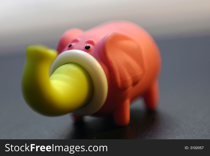 Rubber elephant isolated on a dark background