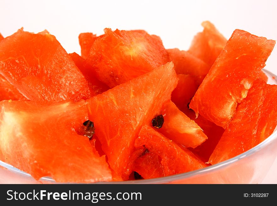 Background of brightly lit red watermelon slices.