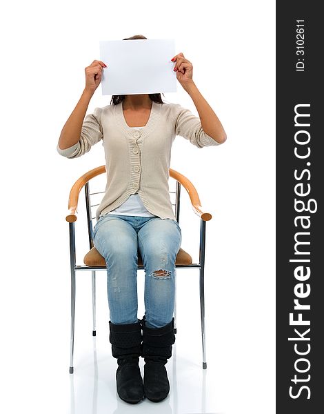 Sitting woman keeps sheet of paper before face